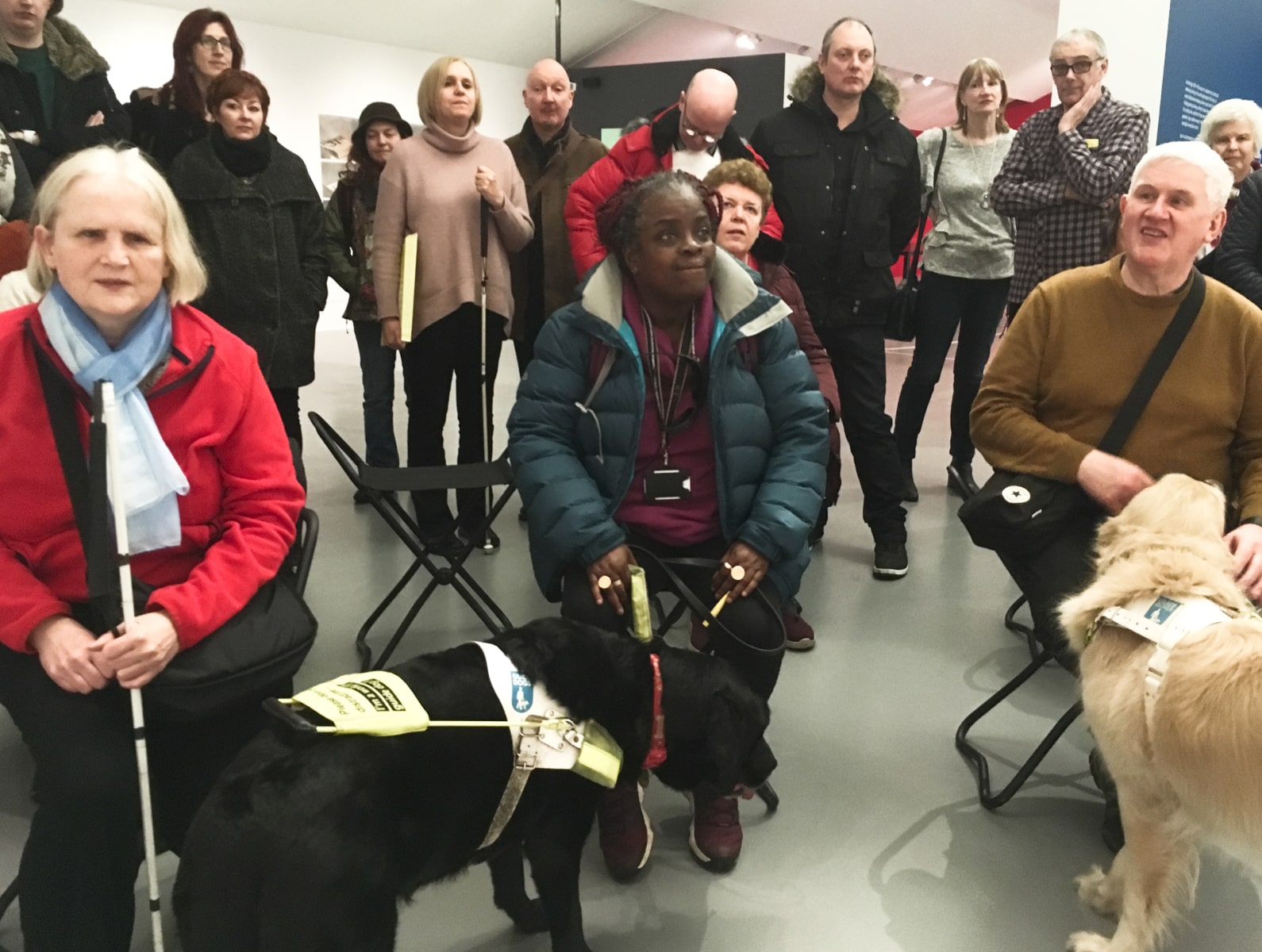 A group of listeners at an audio described tour at Tate Liverpool