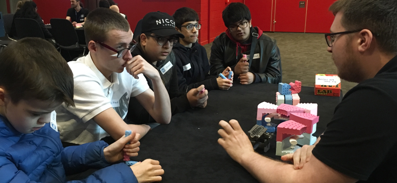 A group of blind and partially sighted school Pupils listening to an audio describer.