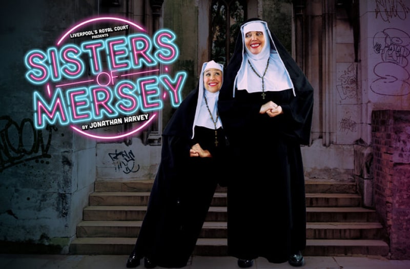In the picture, a big-boned nun stands hands clasped with a smaller nun leaning against her. Both smile sweetly. In the background is a the run-down, graffiti-covered entrance to an ecclesiastical building.