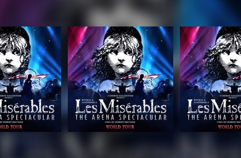 The logo for the tour is the classic close up image of the waif-like Cosette, engraved in black and white. Pink and blue lights shine up into the dark sky and in silhouette below a panorama of the revolutionaries at the barricade, a figure waving a flag
